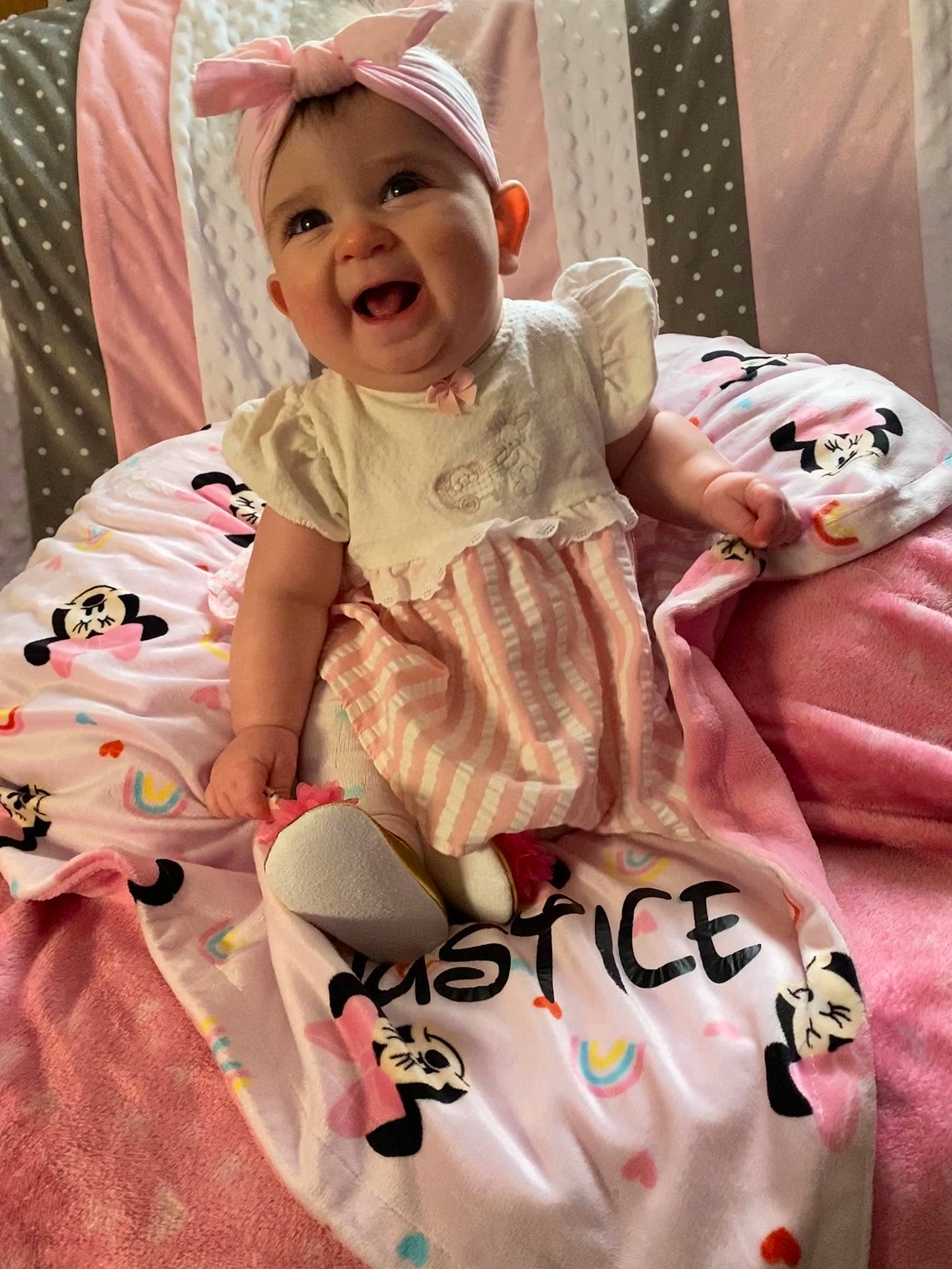 Justice is registered to the contest to win money with this photo: baby, baby_laughing, baby_products, baby_safety, baby_toddler_clothing, cheek, child, comfort, face, facial_expression, happy, headwear, linens, magenta, pattern, person, pink, sleeve, smile, t_shirt