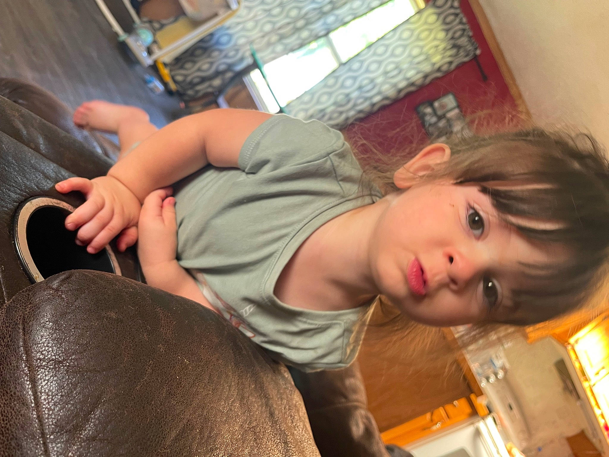 Justice is registered to the contest to win money with this photo: cheek, child, comfort, elbow, flooring, fun, human_body, human_leg, joint, leisure, long_hair, mammal, mouth, person, room, sitting, skin, t_shirt, thigh, toddler