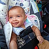 Kodiana joined the competition — help win amazing prizes! baby, child, infant, smiling, happy, portrait, car_seat, car_interior, safety_harness, seatbelt, floral_pattern, blanket, plush_toy, clothing, leopard_print, brown_pants, red_buckle, sitting, close_up, automobile