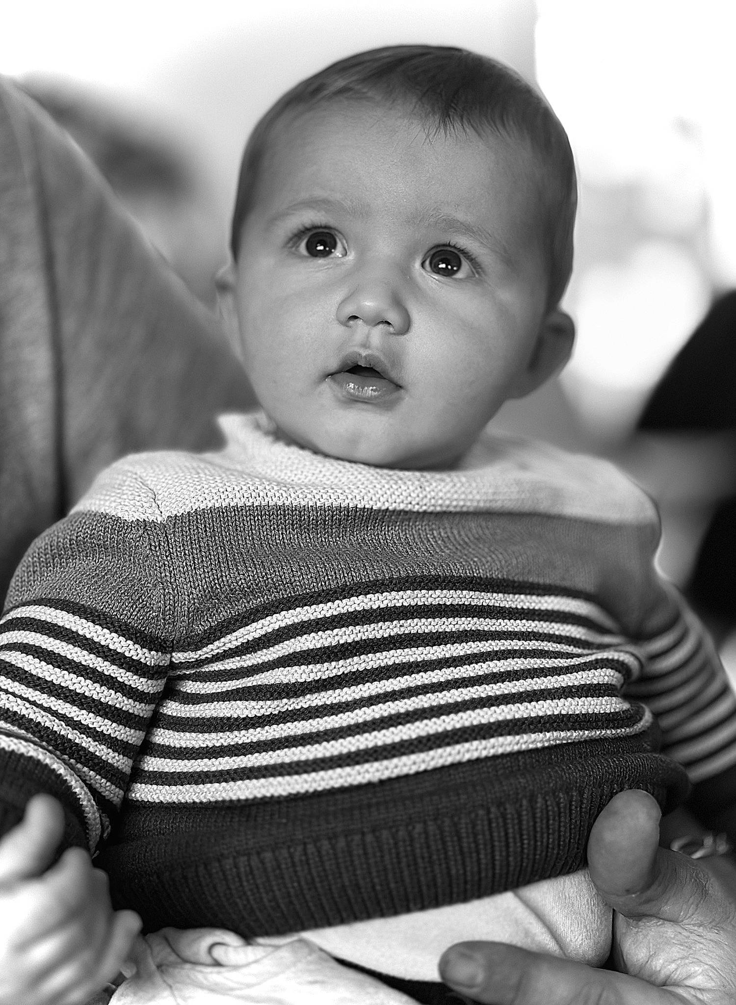 Ayden participe au concours pour gagner de l'argent avec cette photo : arm, baby, black, black_and_white, cheek, comfort, finger, gesture, hand, happy, human_body, mouth, organ, person, photograph, skin, sleeve, smile, style, toddler