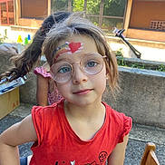 Kayla participe au concours pour gagner de l'argent avec cette photo : child, girl, face_paint, glasses, red_shirt, outdoor, smiling, young, cute, playful, emoji, braid, sunlight, casual, portrait, person, nature, daylight, expression, fashion