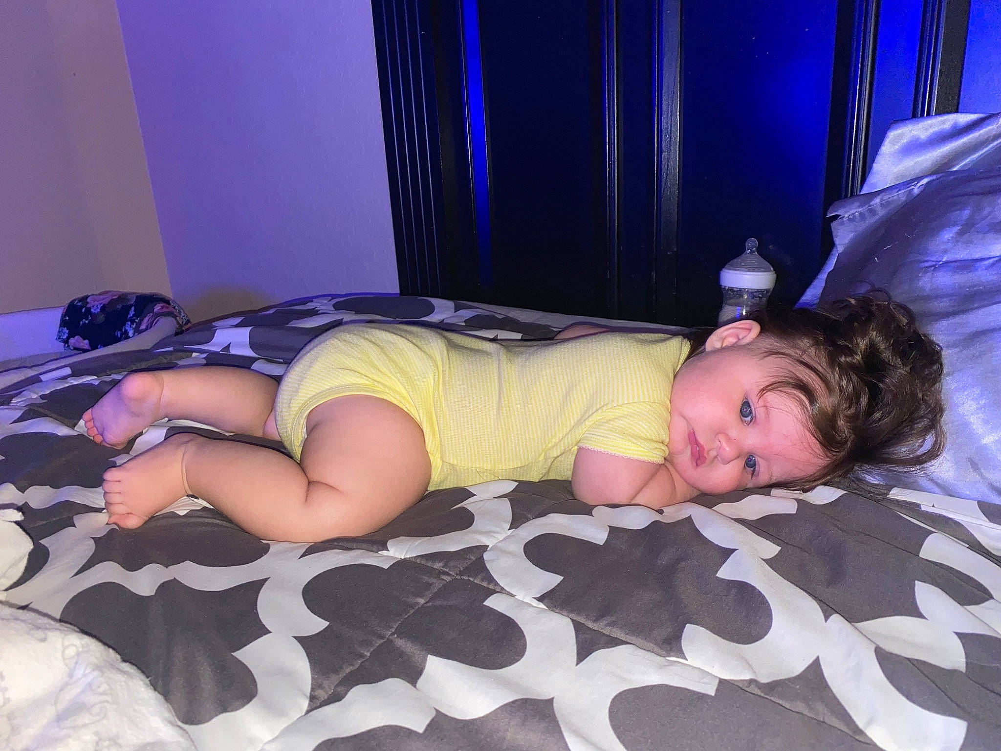 Isabel is registered to the contest to win money with this photo: bed, blue, chest, child, comfort, curtain, elbow, event, flash_photography, flooring, human_leg, knee, leisure, linens, magenta, person, purple, thigh, toddler, trunk