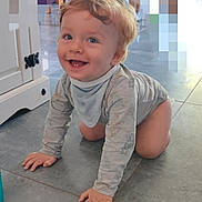 Lyssandro participe au concours pour gagner de l'argent avec cette photo : animal_print, baby, bib, blue_eyes, cabinet, child, crawling, curly_hair, cute, floor, happy, indoor, light, long_sleeve_shirt, person, playful, smiling, tile_floor, toddler, young_child