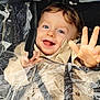 baby, beige_jacket, blue_eyes, child, closeup, cute, face, happy, outdoor, plastic, playful, portrait, rain_cover, raindrops, smiling, stroller, toddler, waving_hand, weather, wet