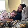 Valerica is registered to the contest to win money with this photo: animal_print, baby, beard, blanket, casual, child, comfort, couch, family, hair, home, indoor, love, man, pillow, portrait, relaxation, toddler, warm_light, window