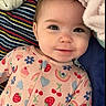Valerica is registered to the contest to win money with this photo: baby, blanket, child, cozy, cupcake, cute, face, flower, happy, indoors, infant, lying_down, onesie, patterned_clothing, portrait, rainbow, smiling, soft_texture, strawberry, striped