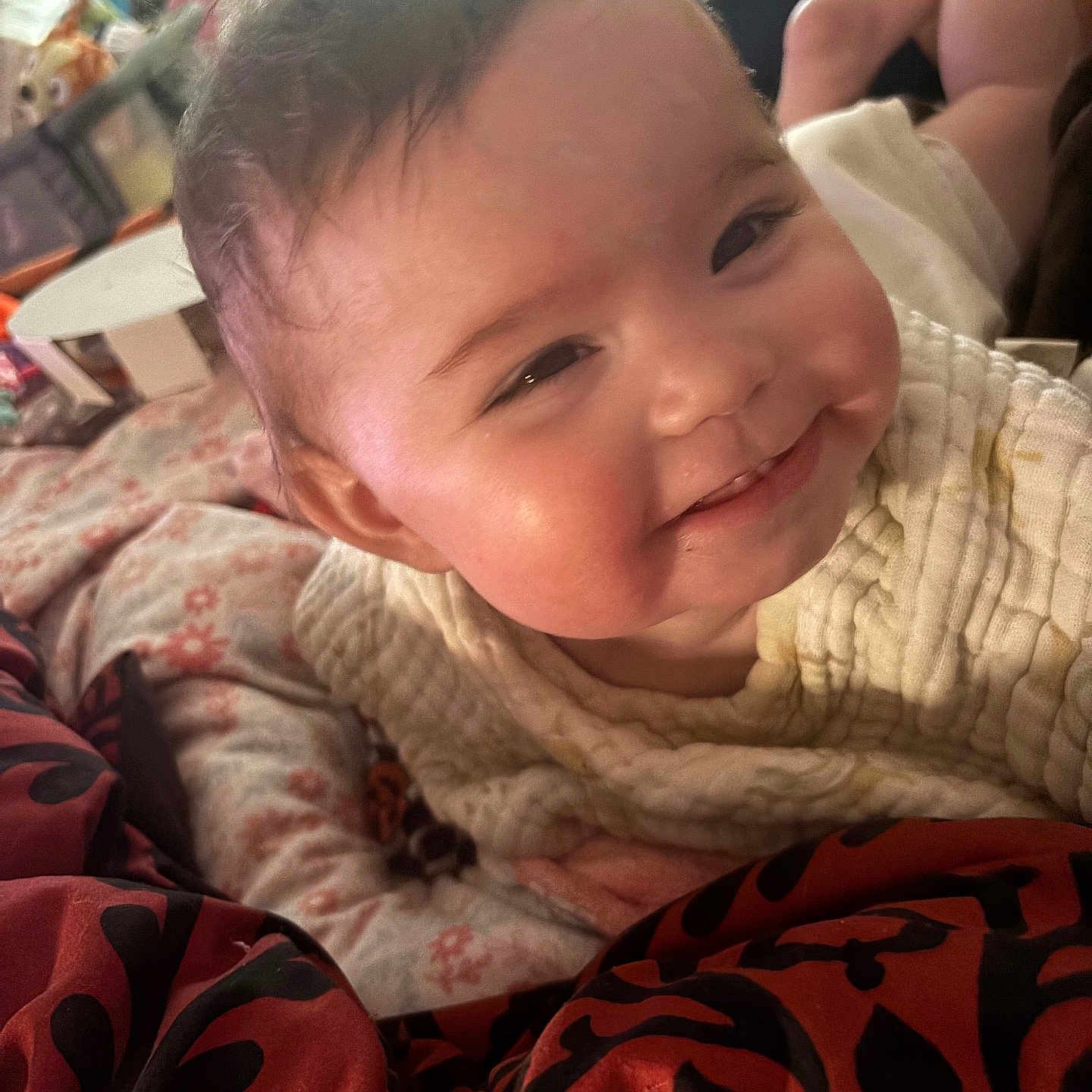Valerica is registered to the contest to win money with this photo: baby, blanket, candid, child, close_up, clothing, comfort, cozy, expression, face, happy, head, indoor, infant, knitwear, person, portrait, smile, soft_fabric, warm_lighting