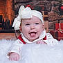 Valerica is registered to the contest to win money with this photo: baby, blanket, child, christmas, clothing, cozy, cute, decorations, festive, fireplace, happy, headband, holiday, indoor, infant, portrait, presents, smiling, warm, white_bow