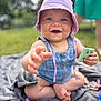 baby, child, blue_eyes, hat, outdoor, grass, blanket, toy, smiling, happy, summer, play, sitting, cute, infant, person, clothing, hand, foot, daylight
