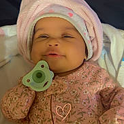 Camiyah joined the competition — help win amazing prizes! baby, infant, pacifier, pink_clothing, floral_pattern, hat, sleepwear, cute, smiling, child, newborn, lying_down, indoors, soft_texture, cozy, blanket, headwear, portrait, baby_girl, peaceful