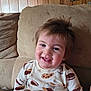 Samuel is registered to the contest to win money with this photo: toddler, child, pajamas, cookies, milk, smile, face, hair, couch, sofa, indoor, wood_paneling, happy, young_child, person, clothing, seated, home, cute, portrait