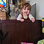 Samuel joined the competition — help win amazing prizes! toddler, child, smiling, indoor, wooden_furniture, hair, face, television, cartoon, clothing, hat, cabinet, box, plastic_bag, door, wall, person, happy, holding, room