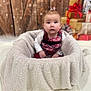Zamara joined the competition — help win amazing prizes! baby, child, plaid, red, blanket, fuzzy, holiday, presents, wrapped_gifts, wooden_wall, indoor, cute, festive, winter, portrait, sitting, soft_texture, warm, decorations, cozy