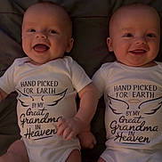 Titus-Pierce is registered to the contest to win money with this photo: baby, infant, smiling, onesie, matching_clothes, holding_hands, face, cute, happy, lying_down, blanket, indoors, portrait, two_babies, newborn, child, toddler, sweet, sibling, family