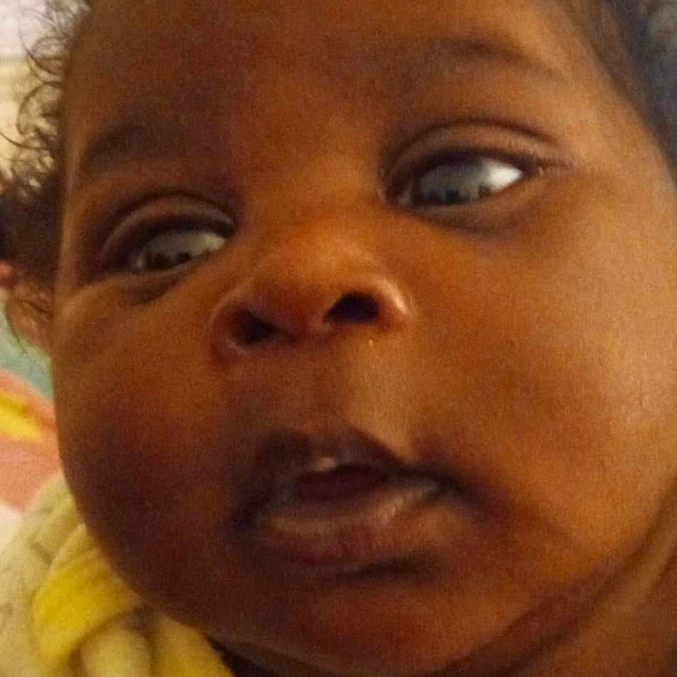 Nakyla joined the competition — help win amazing prizes! baby, child, close_up, cozy, curly_hair, cute, expression, eyes, face, head, indoor, infant, mouth, newborn, person, portrait, skin, soft_lighting, yellow_clothing, young_child