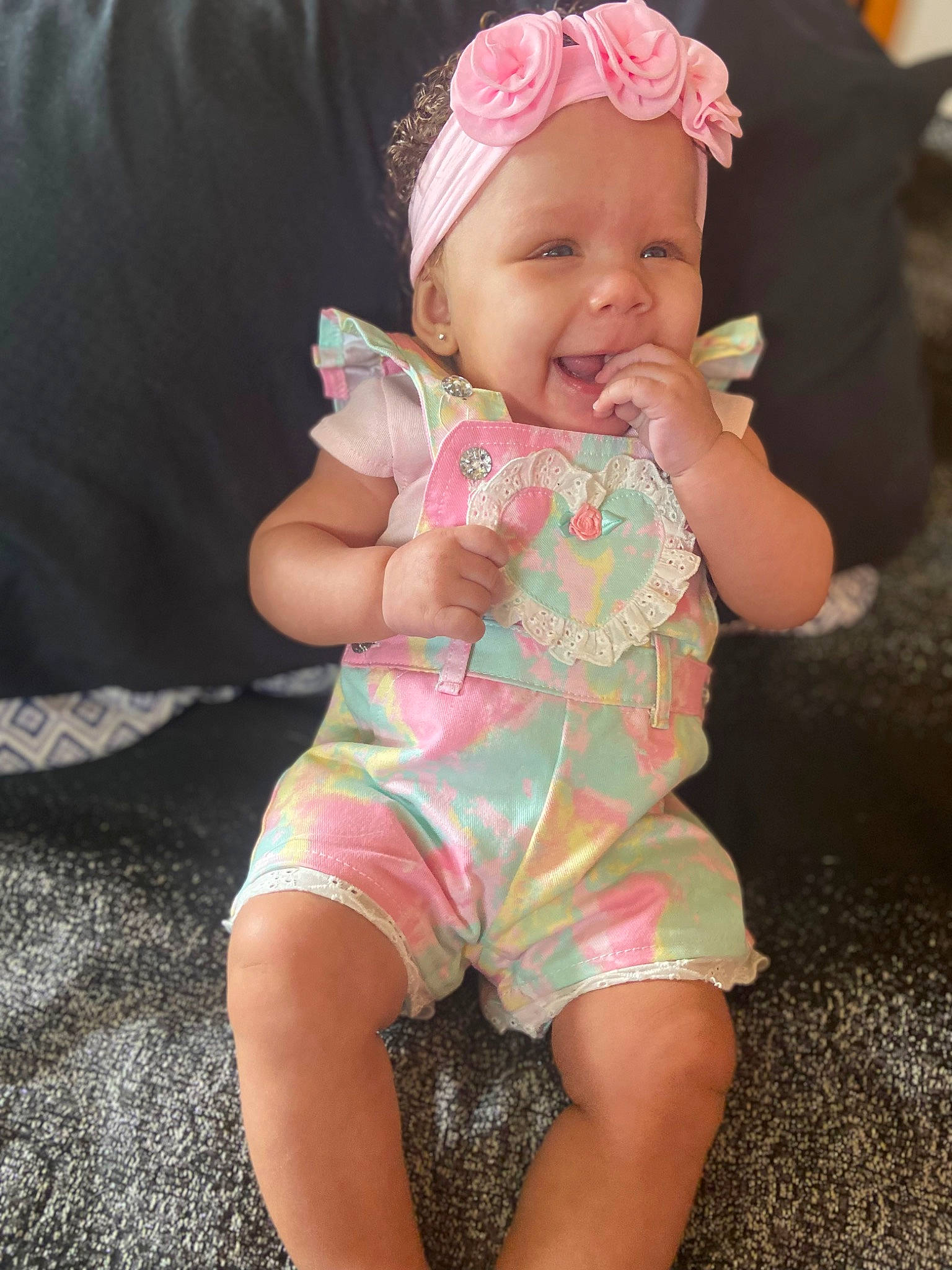 Symphanie is registered to the contest to win money with this photo: baby, baby_toddler_clothing, cap, child, eye, face, facial_expression, finger, fun, hand, happy, headwear, human_body, lip, mouth, person, pink, skin, sleeve, smile