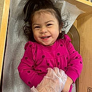 Raelynn joined the competition — help win amazing prizes! toddler, child, smiling, happy, polka_dot, dress, pink, gloves, hand, changing_table, hair, pony_tail, indoor, baby, person, cute, playful, skin, face, expression