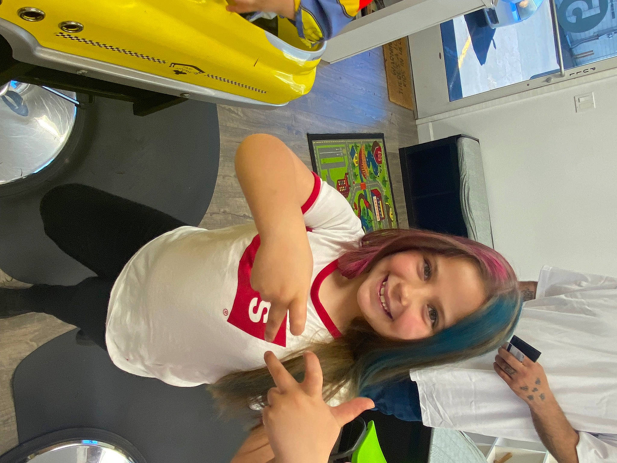 Peyton is registered to the contest to win money with this photo: automotive_design, automotive_tire, automotive_wheel_system, elbow, fun, happy, hat, human_leg, joy, leisure, person, personal_protective_equipment, room, smile, t_shirt, thigh, tire, vacation, vehicle_door, wheel