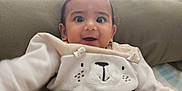 Aarav is registered to the contest to win money with this photo: baby, child, smiling, face, indoors, clothing, toy, happy, infant, cute, person, sitting, home, furniture, playful, young_child, portrait, warm, cozy, expression