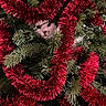 cat, christmas_tree, tinsel, red, green, holiday, festive, ornaments, evergreen, branches, hidden, peeking, face, eyes, nose, fur, indoor, decoration, portrait, funny