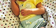 Rosie joined the competition — help win amazing prizes! baby, newborn, smiling, sleeping, blanket, polka_dot, clothing, yellow_top, blue_shorts, cute, infant, happy, indoor, soft, cozy, peaceful, relaxed, skin, hand, face