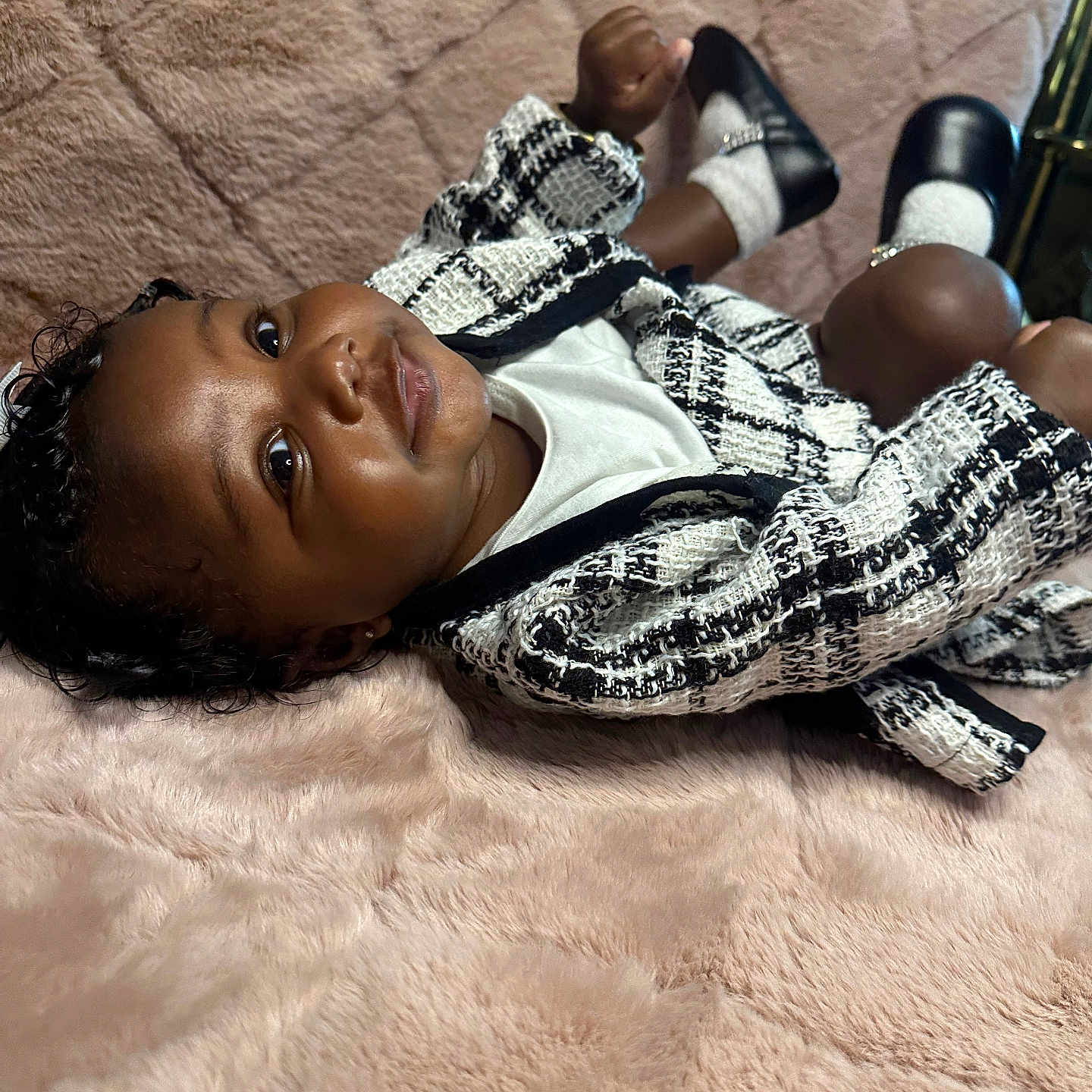 Khaloni joined the competition — help win amazing prizes! baby, black_and_white_jacket, blanket, child, clothing, cute, face, fashion, head, indoor, infant, lying_down, person, plush, portrait, relaxing, shoes, smiling, socks, soft_texture