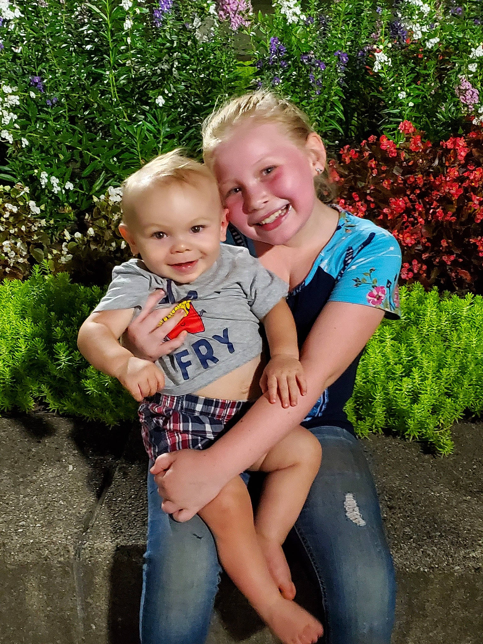 Addison is registered to the contest to win money with this photo: child, daughter, family, fun, garden, grass, happy, jeans, joy, lap, leg, mother, people, person, plant, sibling, sitting, smile, summer, toddler