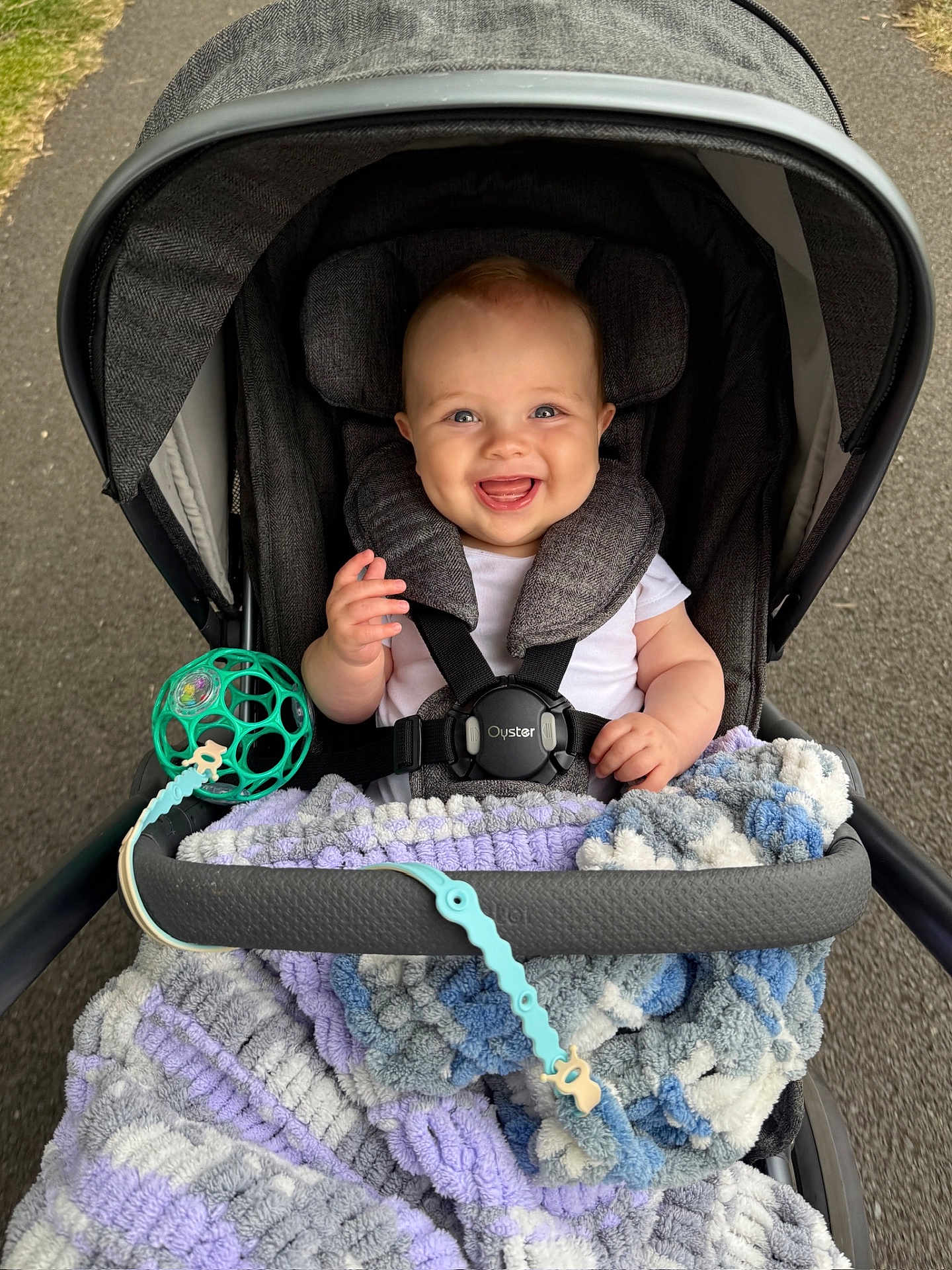 Kody joined the competition — help win amazing prizes! baby, stroller, blanket, smiling, child, outdoor, toy, happy, person, seatbelt, canopy, pavement, park, cute, infant, clothing, plaything, comfort, walking, daytime