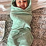 Kody is registered to the contest to win money with this photo: baby, towel, bed, diaper, smile, face, child, pattern, fabric, blanket, comfort, lying_down, wrapped, cute, indoor, portrait, young_child, soft, happy, infant