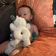 Daxton joined the competition — help win amazing prizes! baby, stuffed_animal, cushion, diaper, pacifier, indoor, orange, soft_toys, child, infant, face, comfort, resting, cute, plush, person, young_child, home, relaxation, blanket