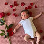 baby, newborn, infant, onesie, blanket, pink_blanket, rose, rose_petal, petals, kiss_mark, lipstick, lying_down, portrait, cute, soft_texture, plant_stem, leaves, skin, barefoot, indoor