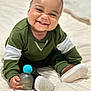 baby, bed, bottle, child, cozy, cute, face, footwear, green_clothing, hand, happy, indoors, infant, portrait, shoes, sitting, skin, smiling, toy, young_child