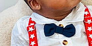 Alexander joined the competition — help win amazing prizes! baby, blue, bow_tie, child, clothing, curious, cute, face, furniture, hand, indoor, infant, portrait, red, seated, soft, stars, stripes, suspenders, white