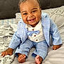 baby, child, smiling, suit, bow_tie, bed, blanket, foot, hand, happy, indoors, portrait, cute, fashion, clothing, infant, person, cozy, buttoned_shirt, head