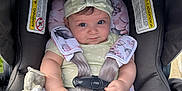 Liz Angeli is registered to the contest to win money with this photo: baby, car_seat, headband, toy, blanket, infant, child, seatbelt, outdoor, grass, cute, smile, face, person, clothing, sitting, soft_toy, fabric, safety_harness, head