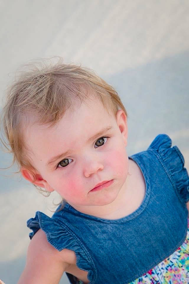 Emilia is registered to the contest to win money with this photo: baby_toddler_clothing, blond, blue, brown_hair, cheek, child, electric_blue, face, flash_photography, fun, happy, iris, lip, nose, person, sitting, skin, sleeve, standing, t_shirt