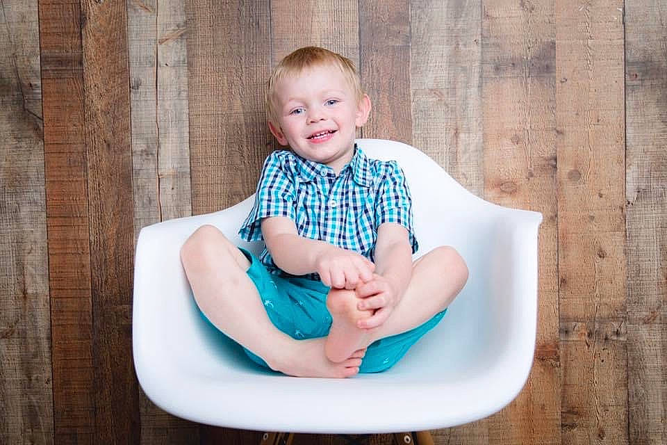 Greyson is registered to the contest to win money with this photo: arm, baby_toddler_clothing, child, circle, clothing, comfort, electric_blue, fun, happy, joy, leisure, pattern, person, portrait_photography, shirt, shorts, sitting, sleeve, smile, t_shirt