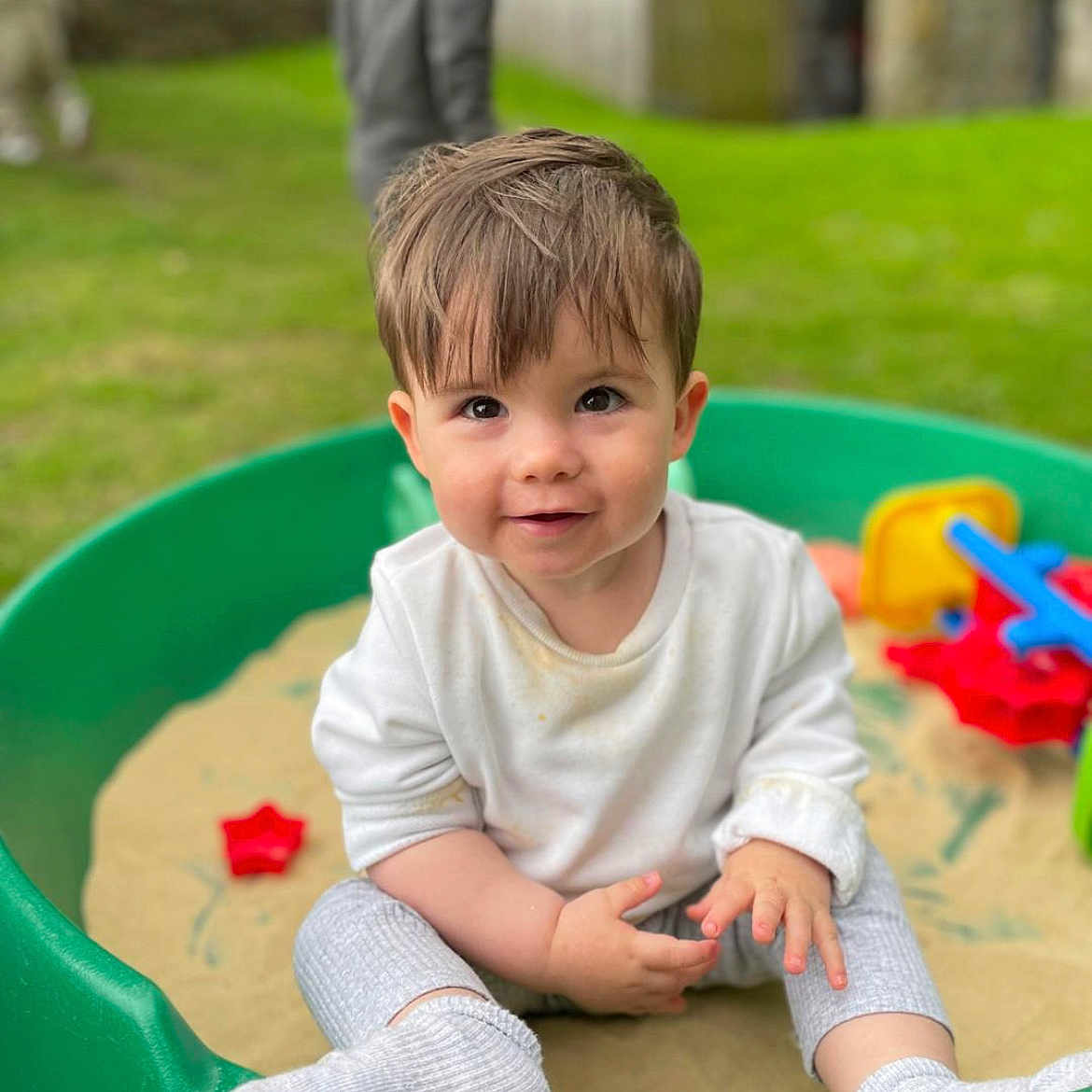 Jaxson joined the competition — help win amazing prizes! bodypart, boy, child, clothing, face, finger, grass, hand, head, hosiery, male, outdoorplayarea, outdoors, person, photography, plant, playarea, portrait, sitting, sock
