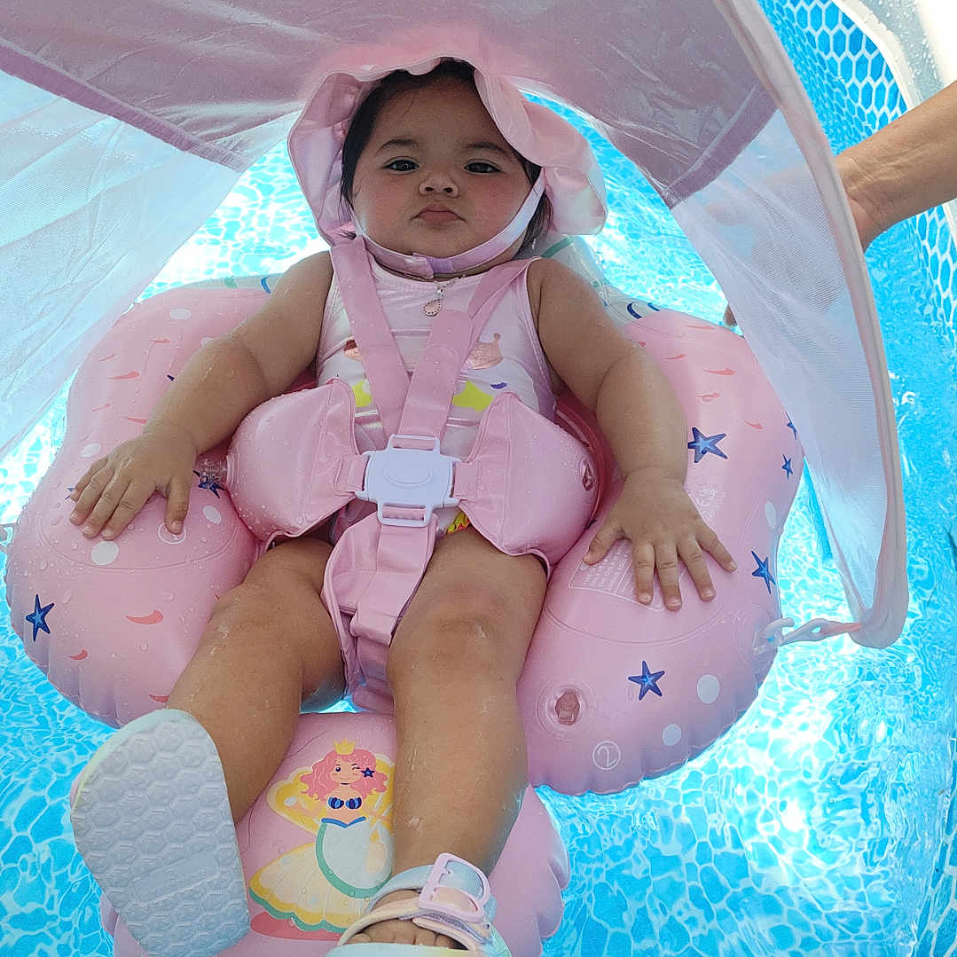 Ema joined the competition — help win amazing prizes! baby, child, cute, float, fun, hand, infant, outdoor, person, pink, pool, relaxing, safety, sandal, summer, sunshade, swimming, swimwear, toy, water