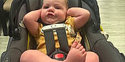 Ivan joined the competition — help win amazing prizes! baby, car_seat, child, indoor, person, infant, floor, chair, hallway, relaxing, casual_clothing, foot, hand, seatbelt, head, expression, light, room, comfort, furniture