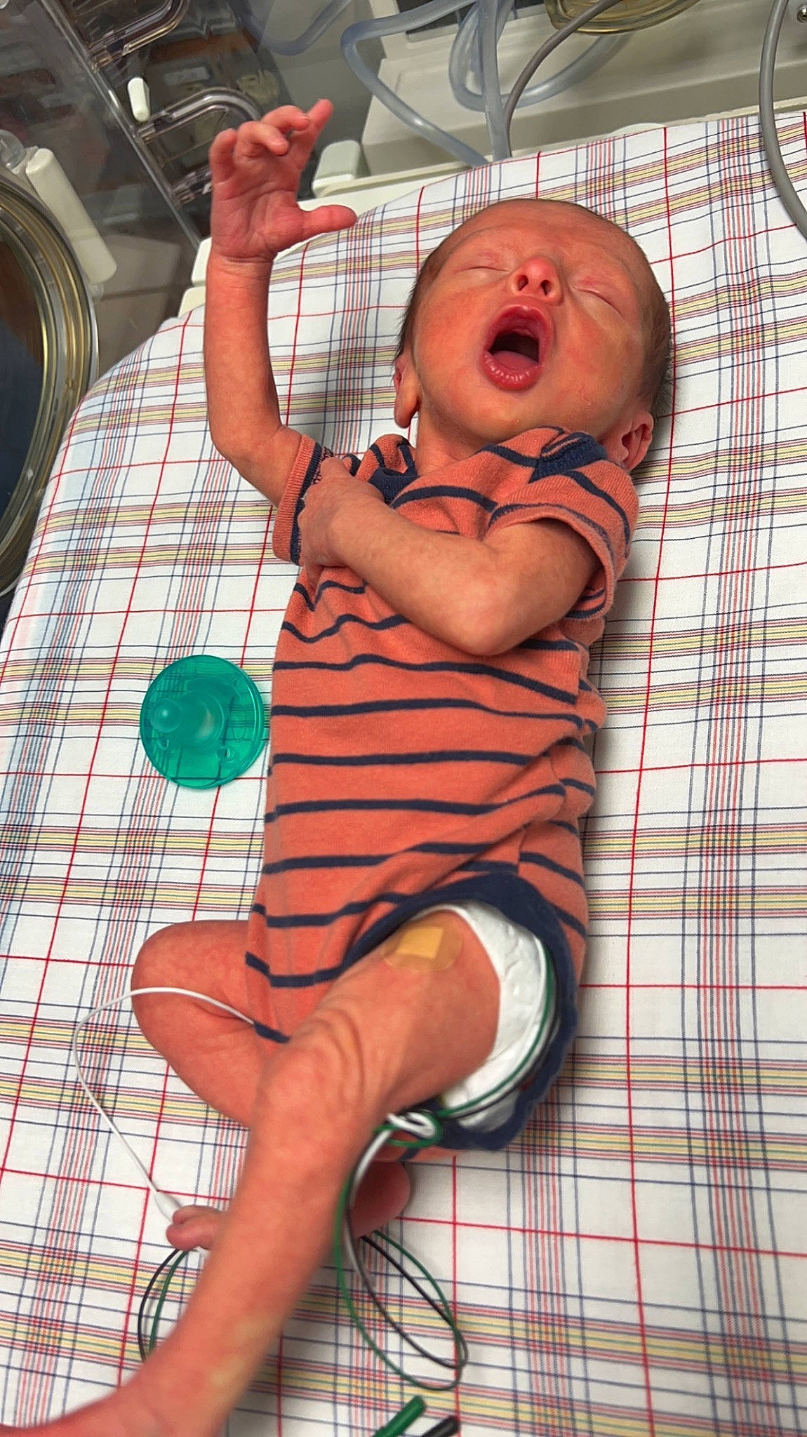 Koby is registered to the contest to win money with this photo: baby, baby_safety, baby_toddler_clothing, bathing, chest, child, comfort, elbow, foot, human_leg, knee, linens, mouth, pattern, person, plaid, sitting, tartan, thigh, thumb