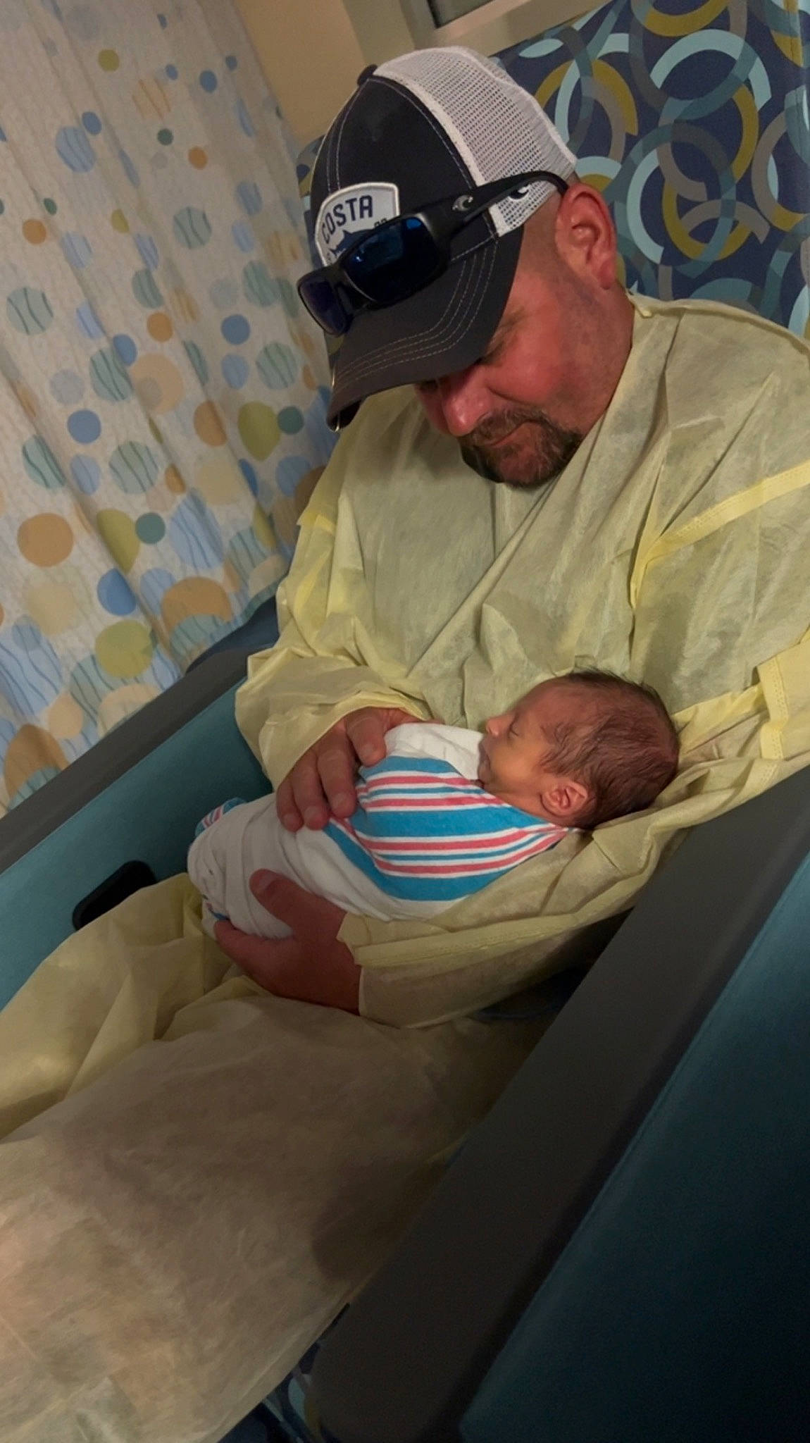 Koby joined the competition — help win amazing prizes! abdomen, baby, baby_products, baseball_cap, cap, comfort, elbow, event, hand, hat, headwear, health_care, hospital, human_body, knee, lap, person, room, service, sitting