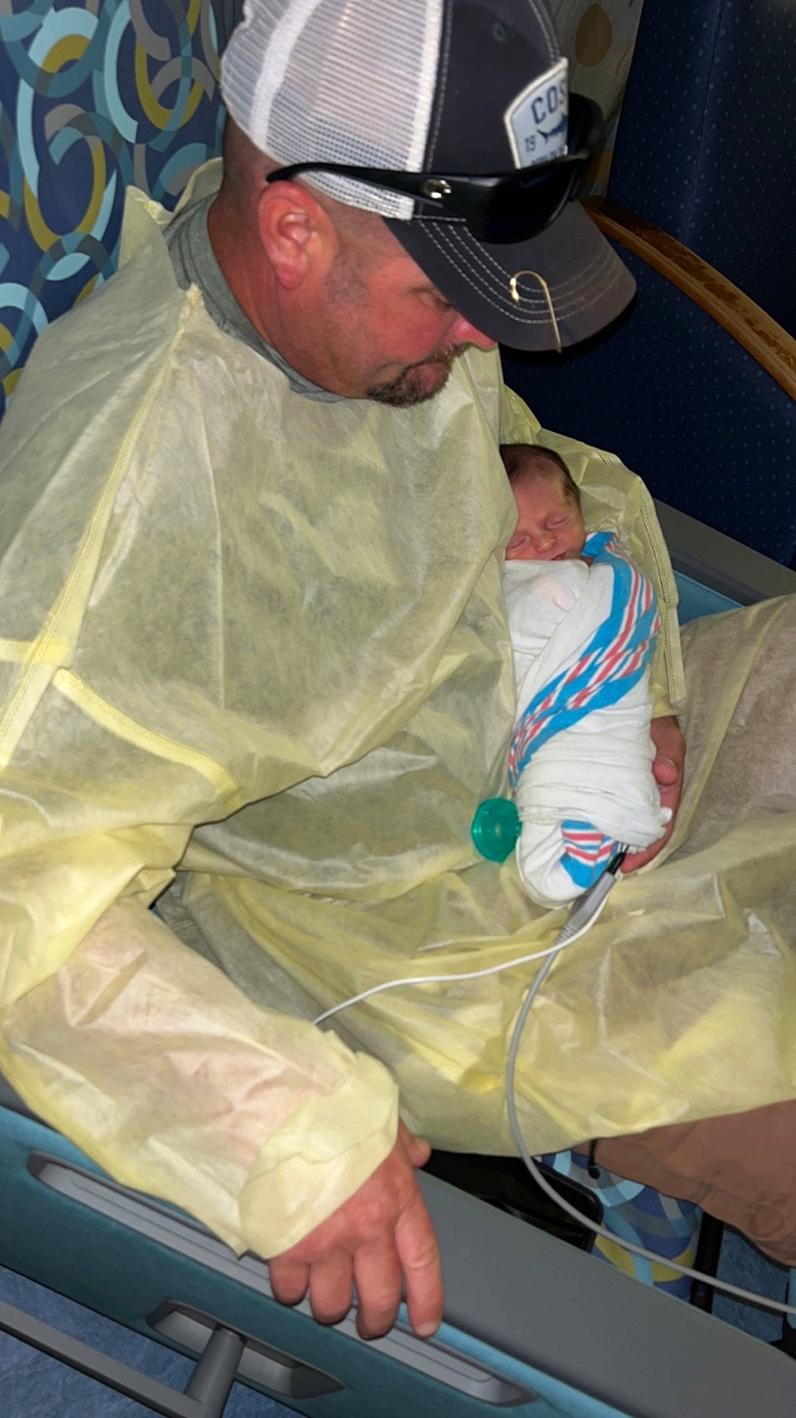 Koby is registered to the contest to win money with this photo: baseball_cap, cap, comfort, elbow, event, hat, headwear, health_care, hospital, human_body, human_leg, medical, medical_procedure, organ, patient, person, personal_protective_equipment, service, sitting, uniform