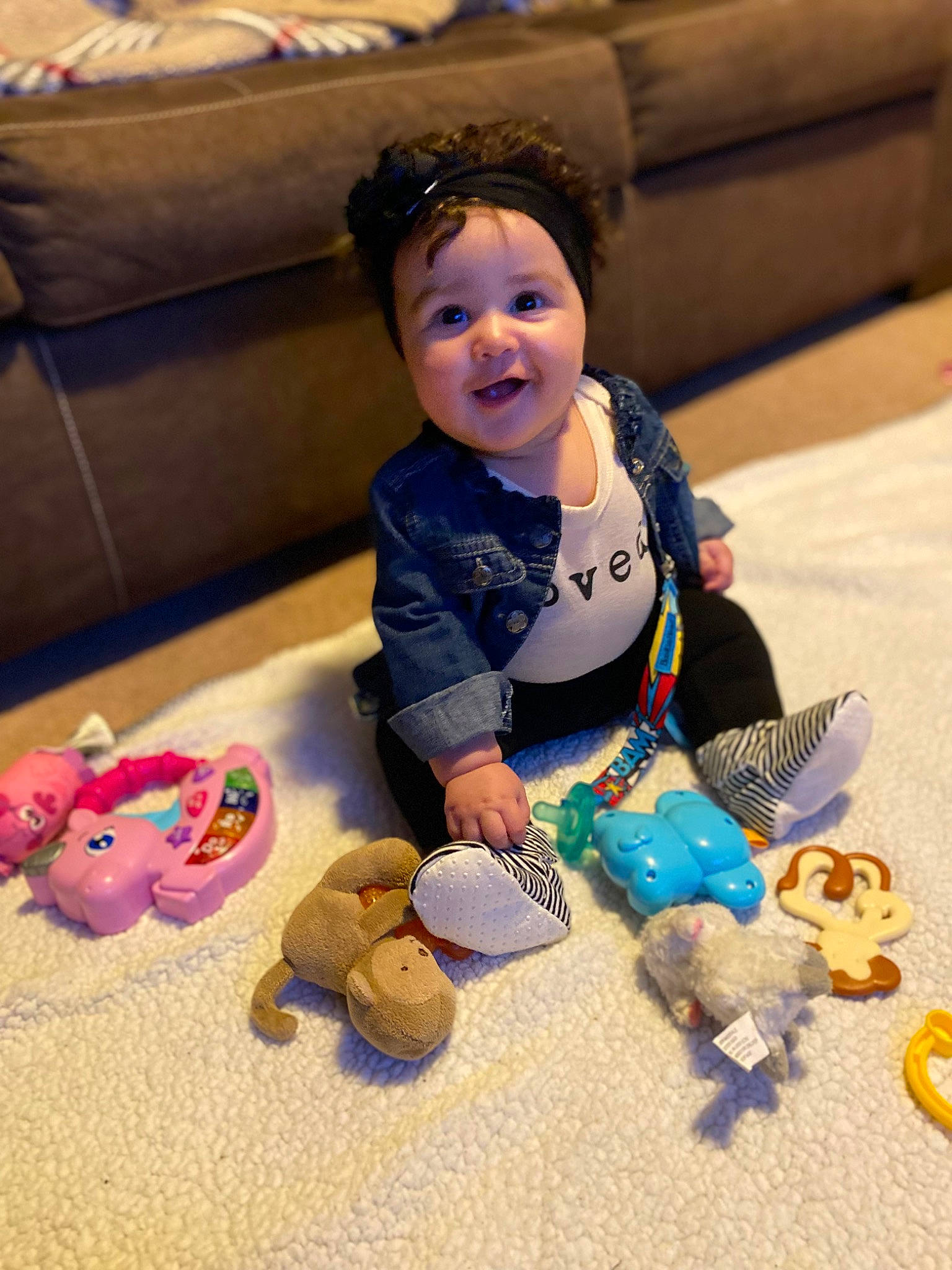 Brynlee Rose joined the competition — help win amazing prizes! baby, baby_toddler_clothing, child, comfort, couch, floor, flooring, fun, happy, mammal, people, person, product, sitting, skin, smile, stuffed_toy, textile, toddler, toy