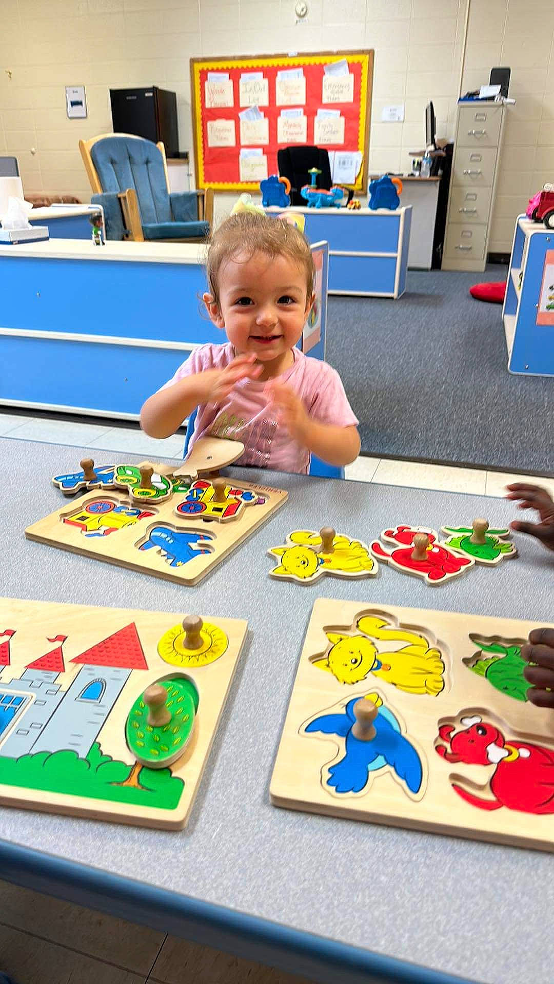 Bailie is registered to the contest to win money with this photo: art, chair, child, educational_toy, flooring, fun, games, indoor_games_and_sports, joy, leisure, person, play, recreation, room, smile, table, tabletop_game, toddler, toy, toy_block