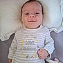 Alexis-Paige is registered to the contest to win money with this photo: baby, infant, smile, pillow, onesie, clothing, striped, animal_print, giraffe, elephant, zebra, rainbow, sun, hand, soft_toy, bed, blanket, cute, face, person