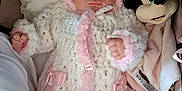 Alexis-Paige is registered to the contest to win money with this photo: baby, infant, knitwear, pink, white, plush_toy, minnie_mouse, cushion, blanket, sleepwear, cute, portrait, child, soft_toy, cozy, warm_clothing, indoor, pajamas, hat, ribbon