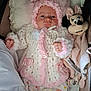 baby, blanket, child, cozy, cushion, cute, hat, indoor, infant, knitwear, minnie_mouse, pajamas, pink, plush_toy, portrait, ribbon, sleepwear, soft_toy, warm_clothing, white