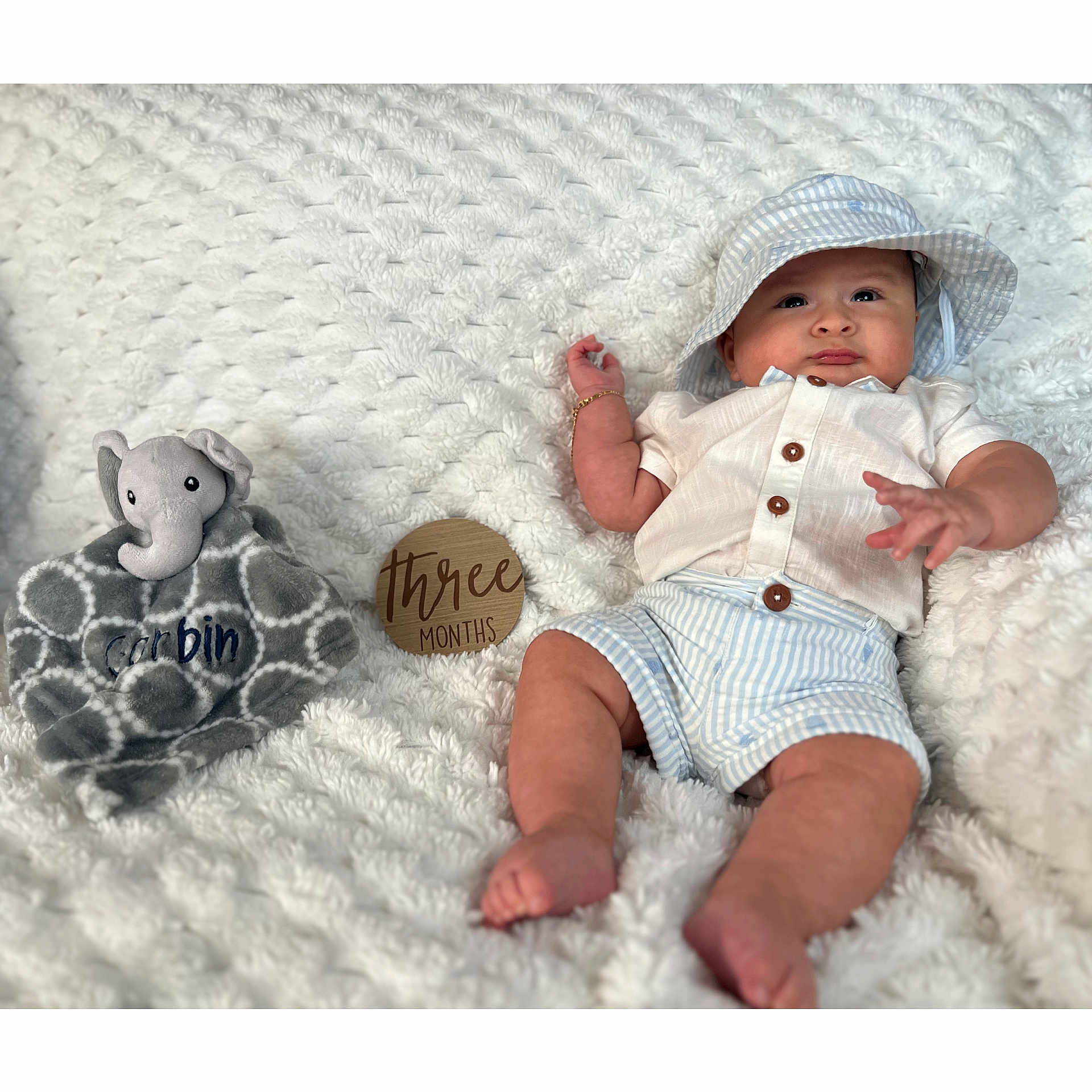 Corbin joined the competition — help win amazing prizes! baby, bodypart, bonnet, cap, clothing, doll, face, finger, hand, hat, head, newborn, person, photography, portrait, shorts, sitting, sunhat, teddybear, toy
