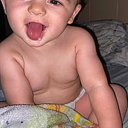 Levi is registered to the contest to win money with this photo: baby, child, tongue, drool, blanket, diaper, skin, smile, happy, face, hand, bed, indoor, cute, infant, expression, person, young, closeup, comfort